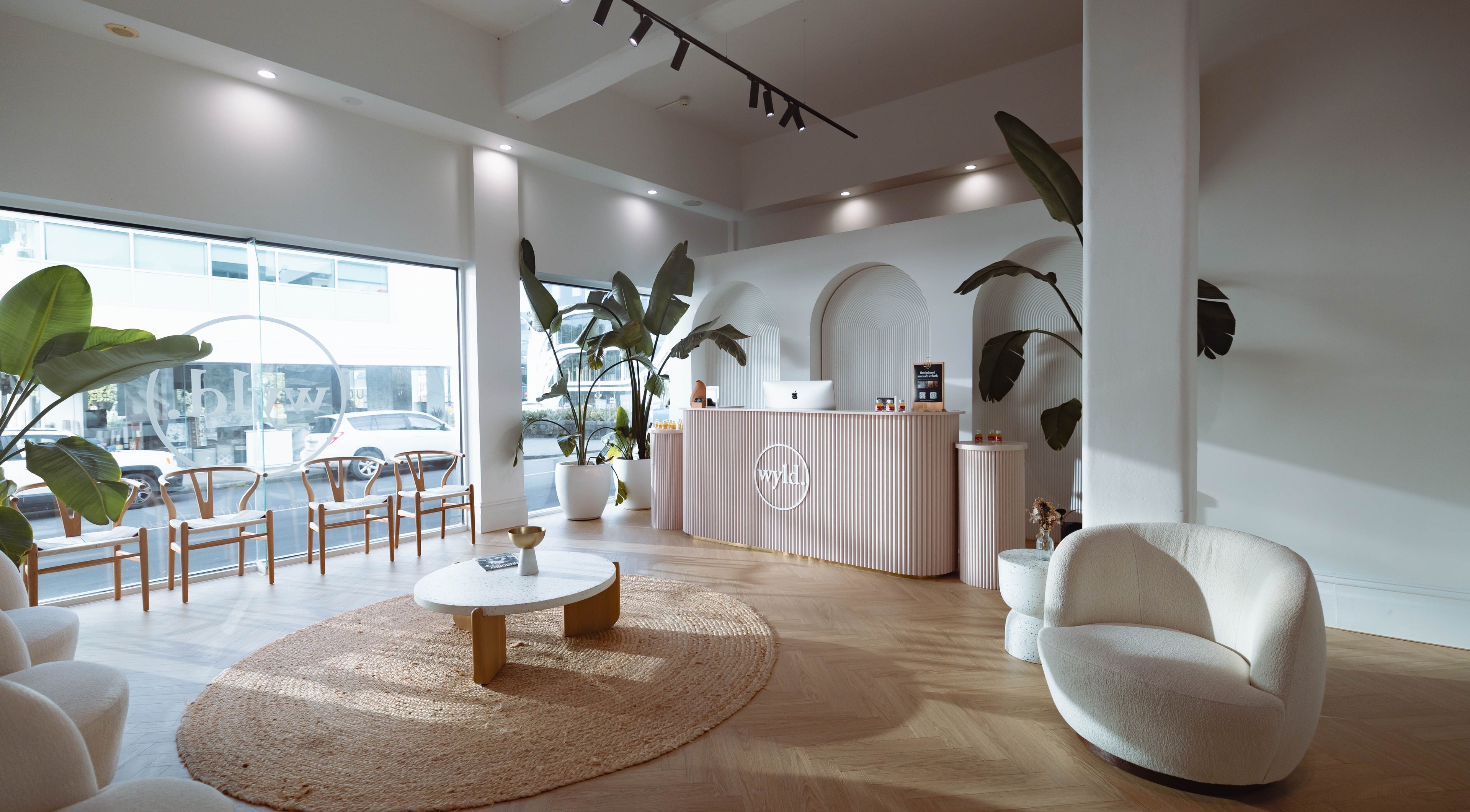 Sophisticated interior of WYLD Newmarket, Auckland, Auckland, NZ, featuring modern decor and lush plants.