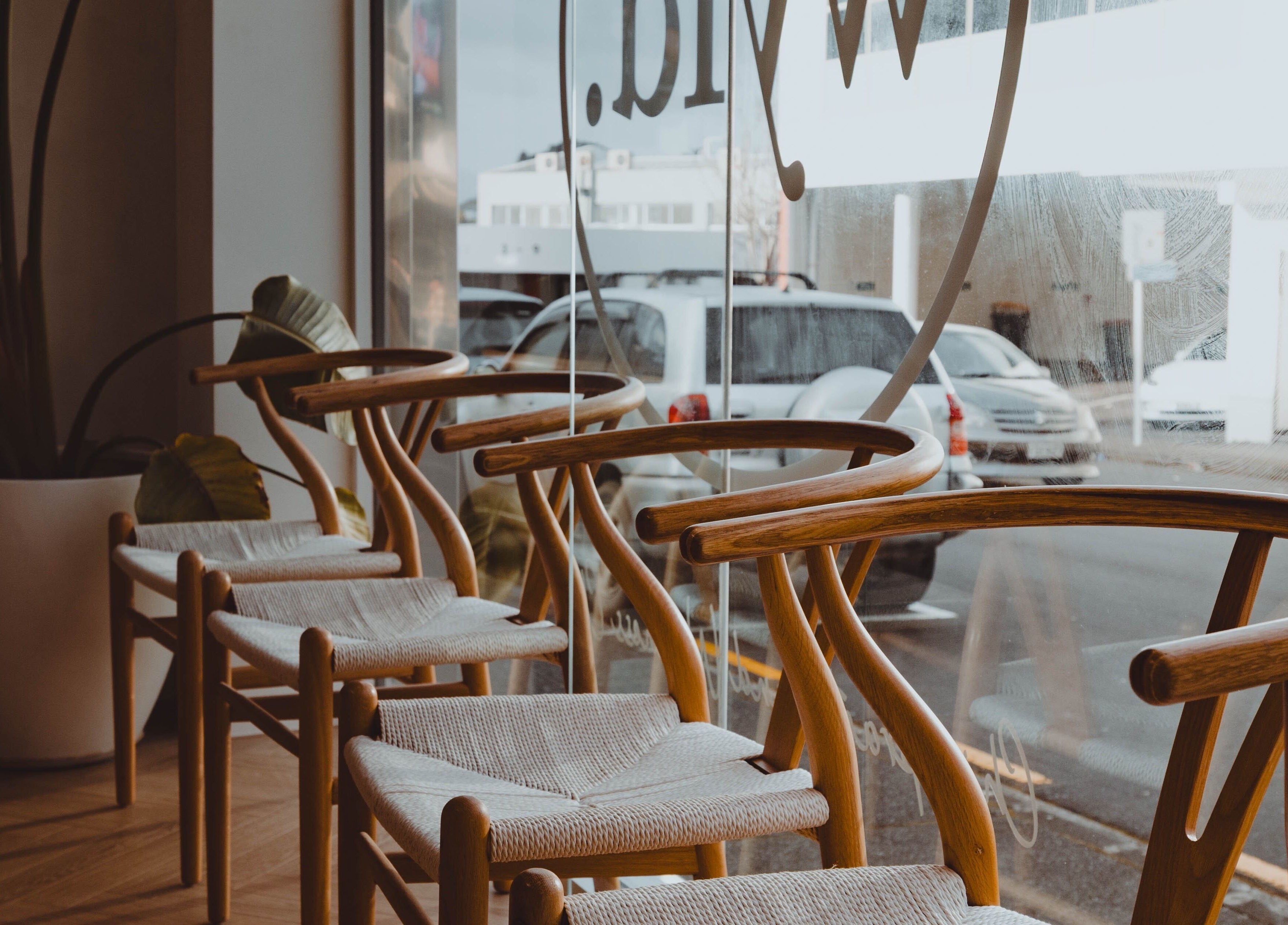 Modern wooden chairs in WYLD Newmarket, Auckland, NZ offer stylish comfort and elegance.