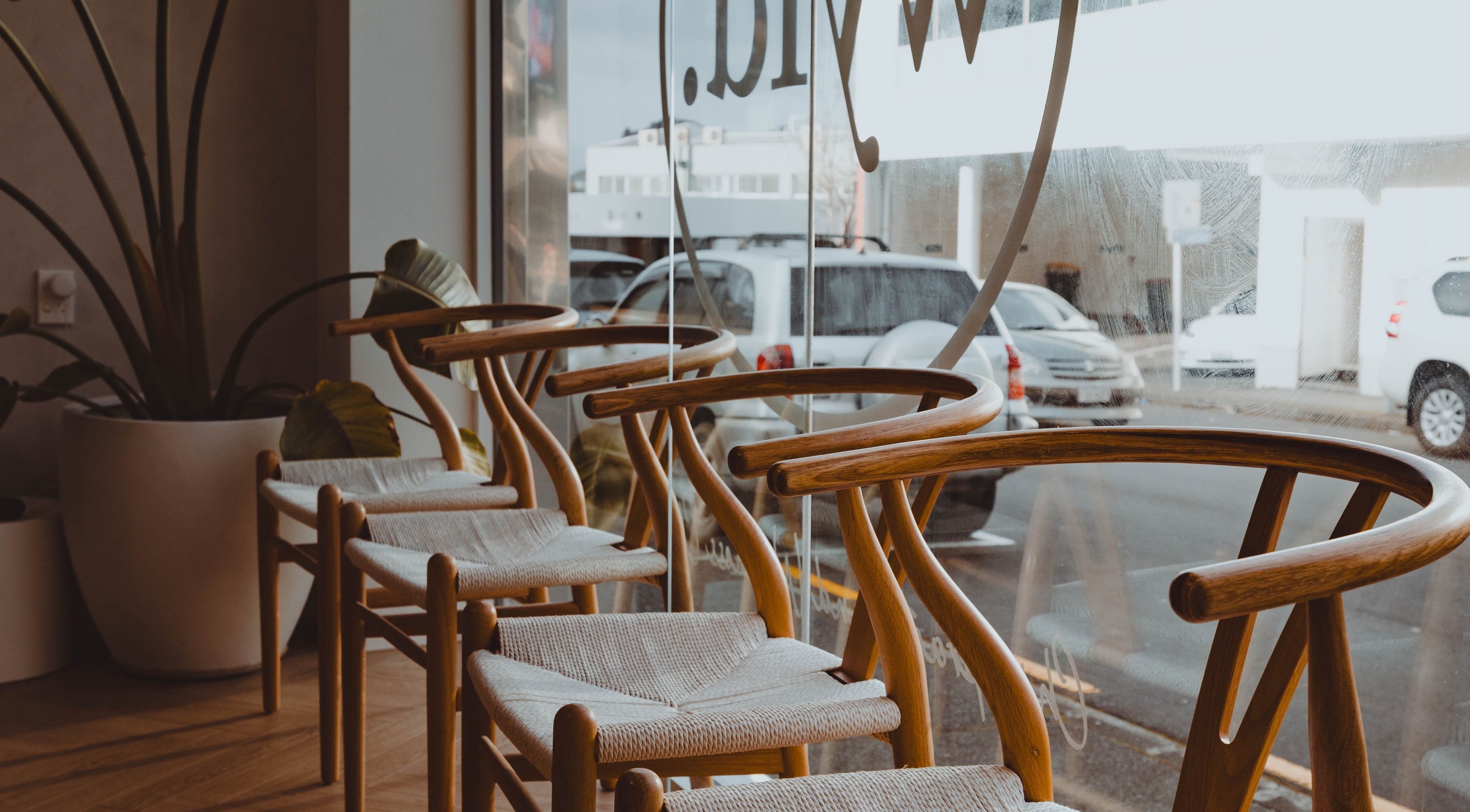 Modern wooden chairs in WYLD Newmarket, Auckland, NZ offer stylish comfort and elegance.