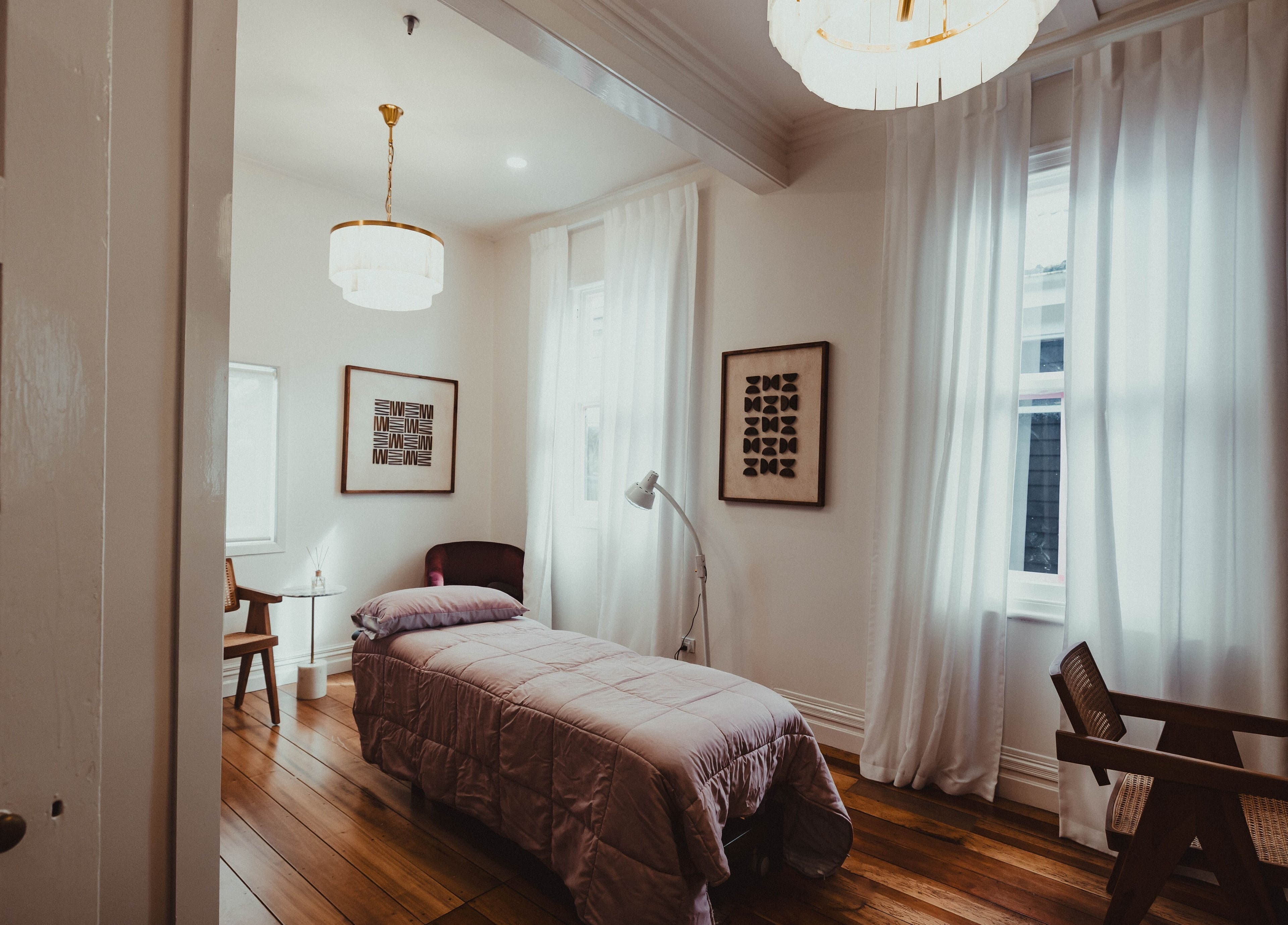 Peaceful and elegant treatment room at WYLD Howick, Auckland, Auckland, NZ with cozy decor and soft lighting.