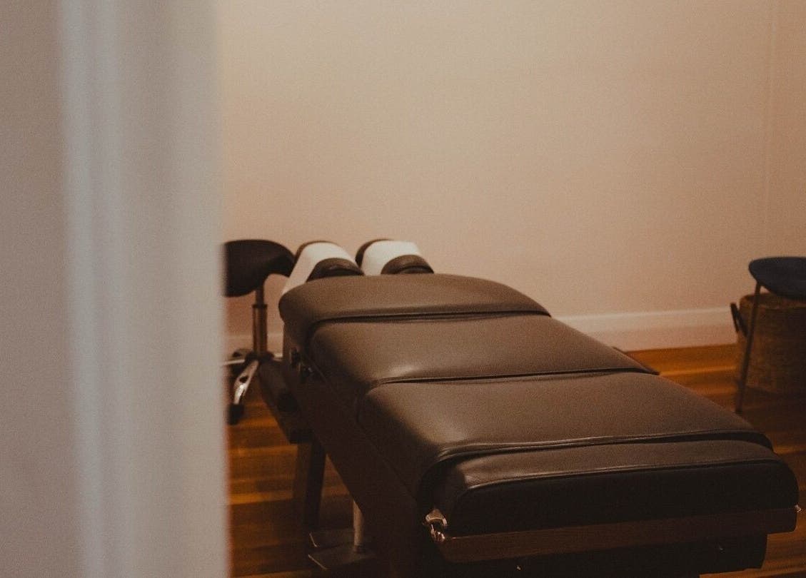 Chic treatment room at WYLD Howick, Auckland, NZ, featuring a massage table and calming decor.