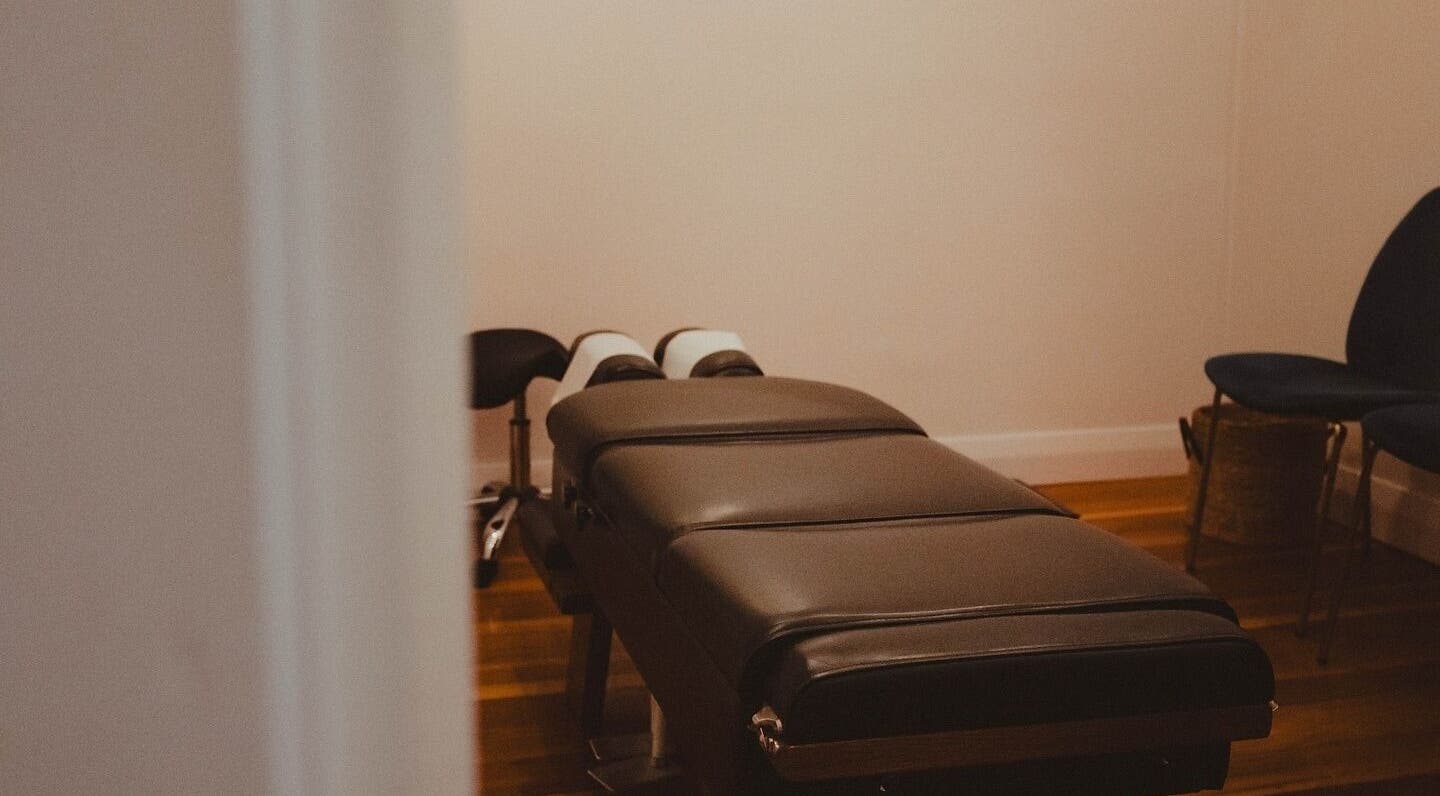 Chic treatment room at WYLD Howick, Auckland, NZ, featuring a massage table and calming decor.
