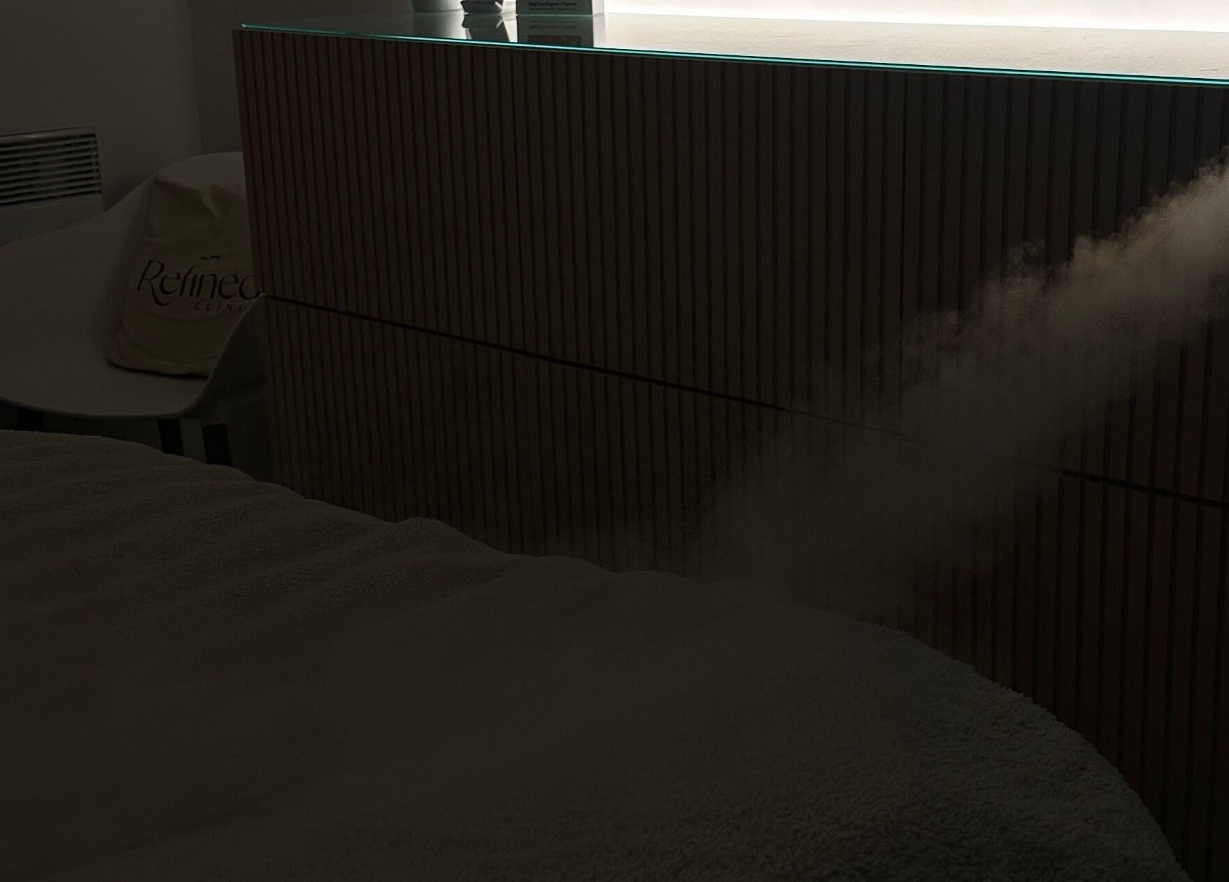 A calming mist disperses in Refined Clinic, Baildon, England, creating a tranquil atmosphere for relaxation.