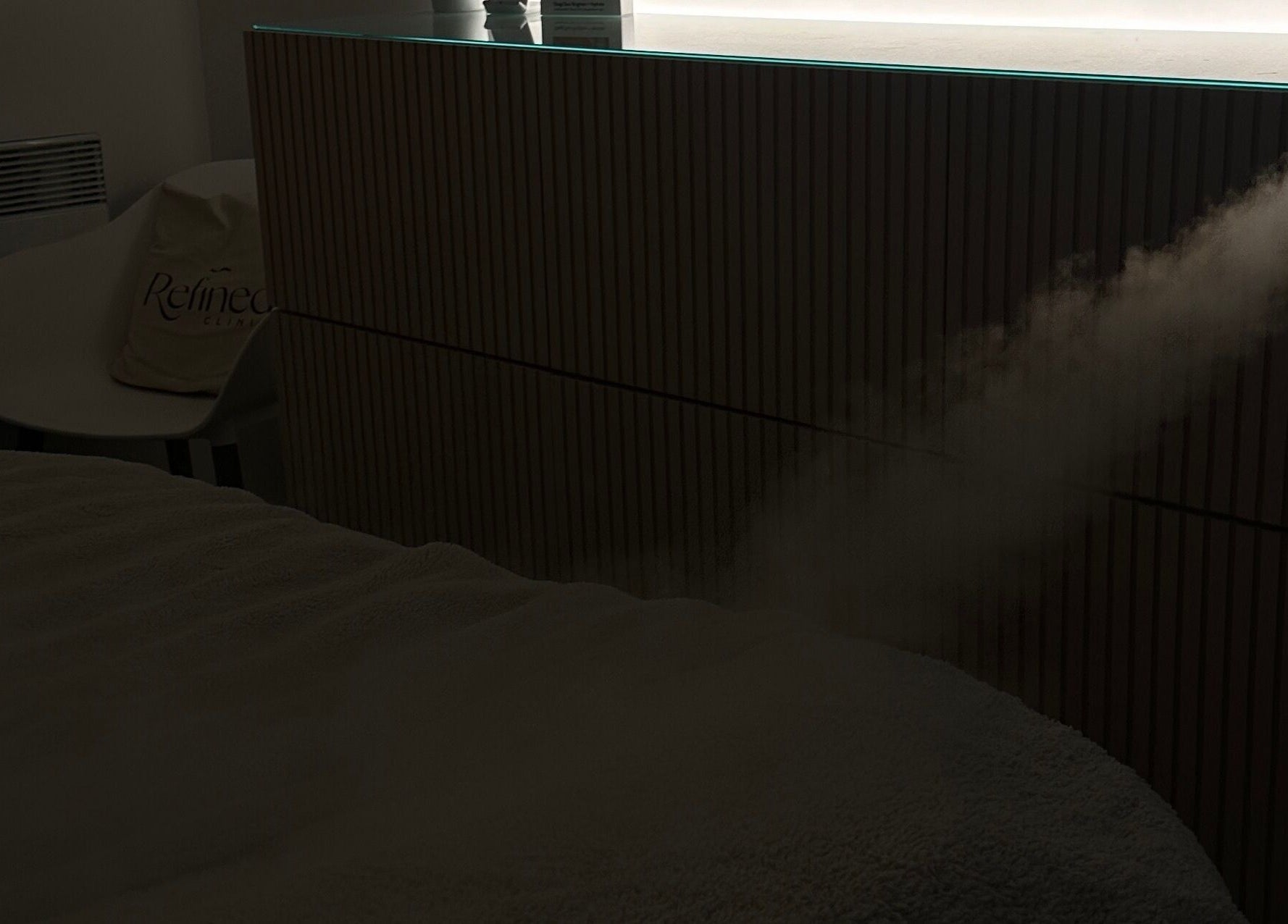 A calming mist disperses in Refined Clinic, Baildon, England, creating a tranquil atmosphere for relaxation.