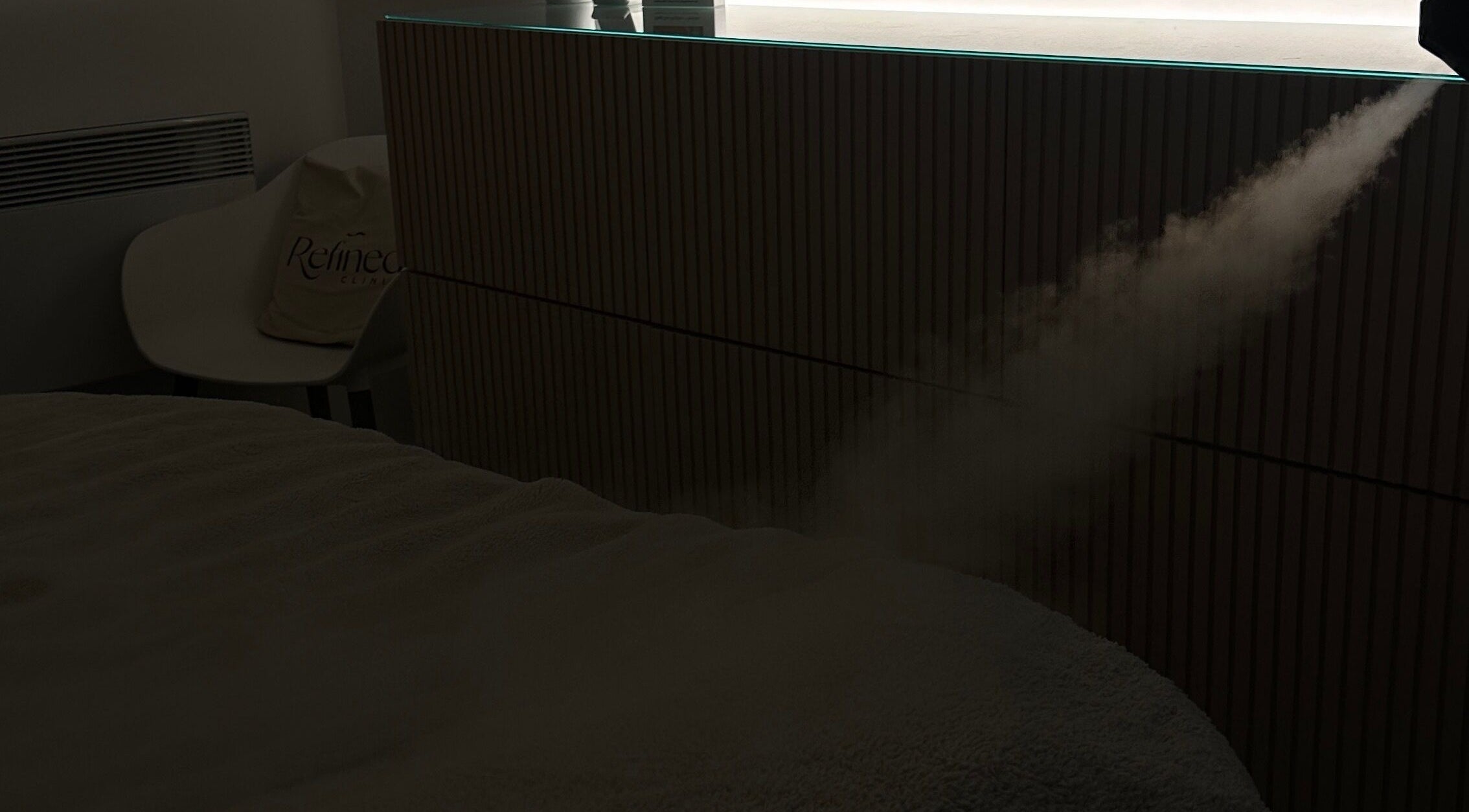 A calming mist disperses in Refined Clinic, Baildon, England, creating a tranquil atmosphere for relaxation.