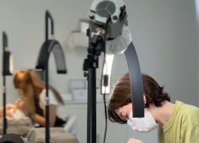 Beauticians performing lash treatments at Brow And Lash Up Bay Ridge, New York, New York, US.