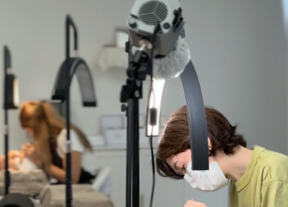 Beauticians performing lash treatments at Brow And Lash Up Bay Ridge, New York, New York, US.