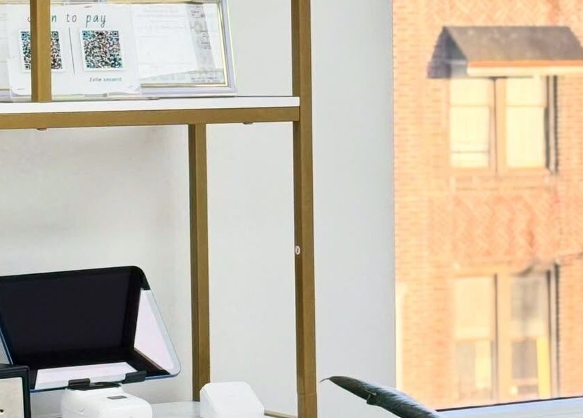 Modern reception area at Brow And Lash Up Bay Ridge, New York, featuring sleek decor and tech amenities.