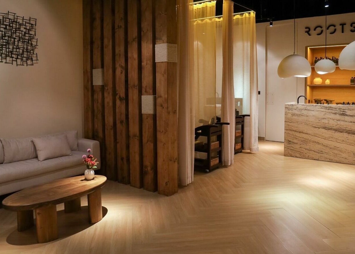Elegant interior of Roots Lab Beauty Salon in Dubai, AE, featuring cozy seating and ambient lighting.