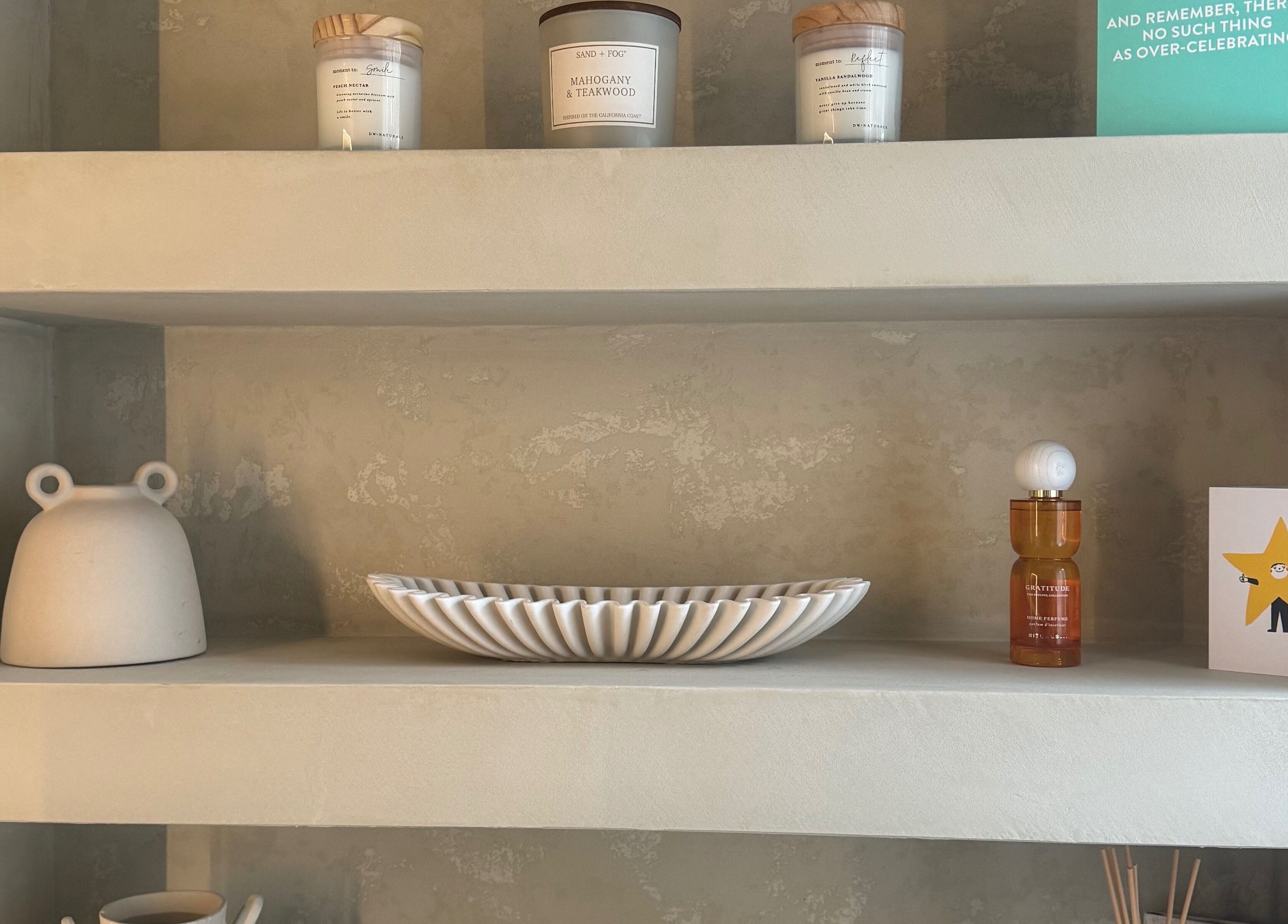 Elegant display shelves at Hygge Well in Otley, England, GB. Featuring candles, decor, and wellness products.