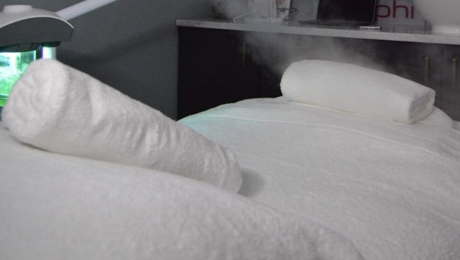 Luxurious spa treatment area at Rsg Aesthetics, Cape Town, Western Cape, ZA, showcasing towels and ambient lighting.
