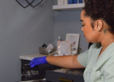 A skilled therapist at Rsg Aesthetics in Cape Town, Western Cape, ZA, prepares tools for a beauty treatment.