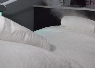 Luxurious spa bed setup at RSG Aesthetics, Cape Town, Western Cape, ZA, showcasing plush towels and relaxing ambiance.