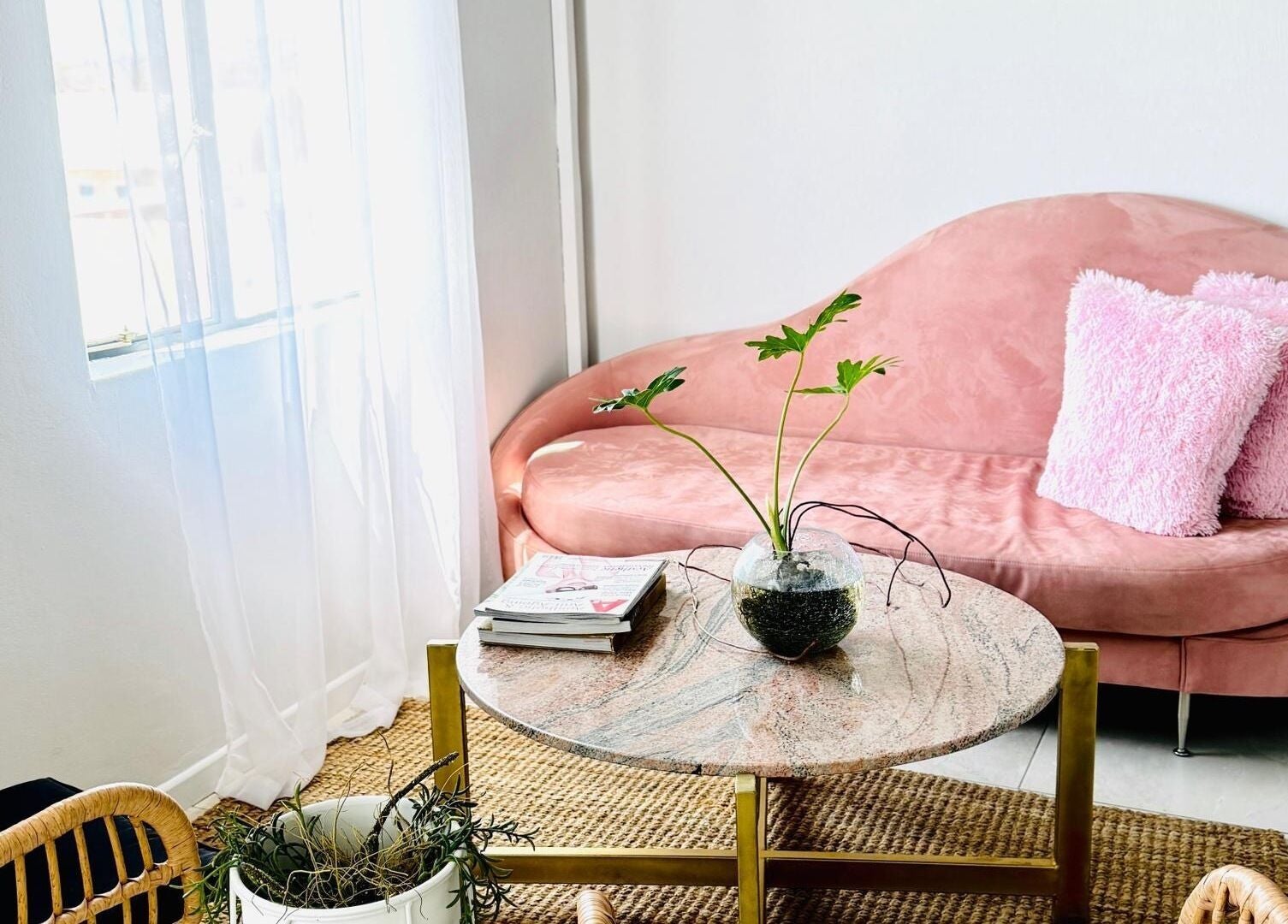 Elegant blush seating area at Face it Spa, Tsumeb, Oshikoto Region, NA, featuring a cozy pink sofa and chic decor.