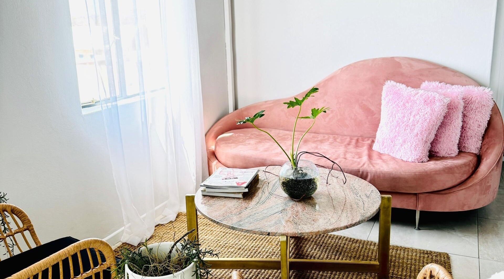 Elegant blush seating area at Face it Spa, Tsumeb, Oshikoto Region, NA, featuring a cozy pink sofa and chic decor.