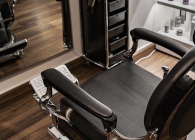 Luxurious barber chair at Espada in Dhahran, Eastern Province, SA, showcasing sleek design and comfort.