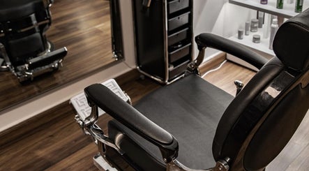 Luxurious barber chair at Espada in Dhahran, Eastern Province, SA, showcasing sleek design and comfort.