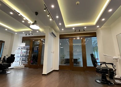 Bright, spacious salon interior at Espada, Dhahran, Eastern Province, SA with modern chairs and shelves.