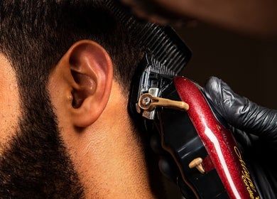 Close-up of a barber trimming hair at Espada, Dhahran, Eastern Province, SA.