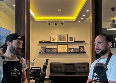 Espada lounge view in Dhahran, Eastern Province, SA, with two personnel in uniform interacting warmly.