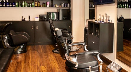 Modern beauty salon interior at Espada, Dhahran, Eastern Province, SA featuring sleek black chairs.