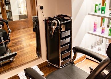 Elegant salon interior at Espada, Dhahran, Eastern Province, SA, showcasing a modern styling chair and products.