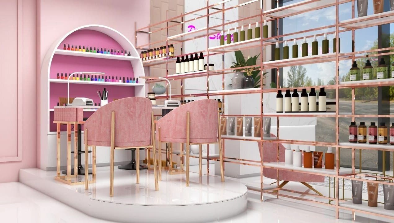Elegant beauty setup at Pink Stiletto by Shweta, Dubai, AE. Cozy pink chairs and colorful nail polishes create a stylish vibe.