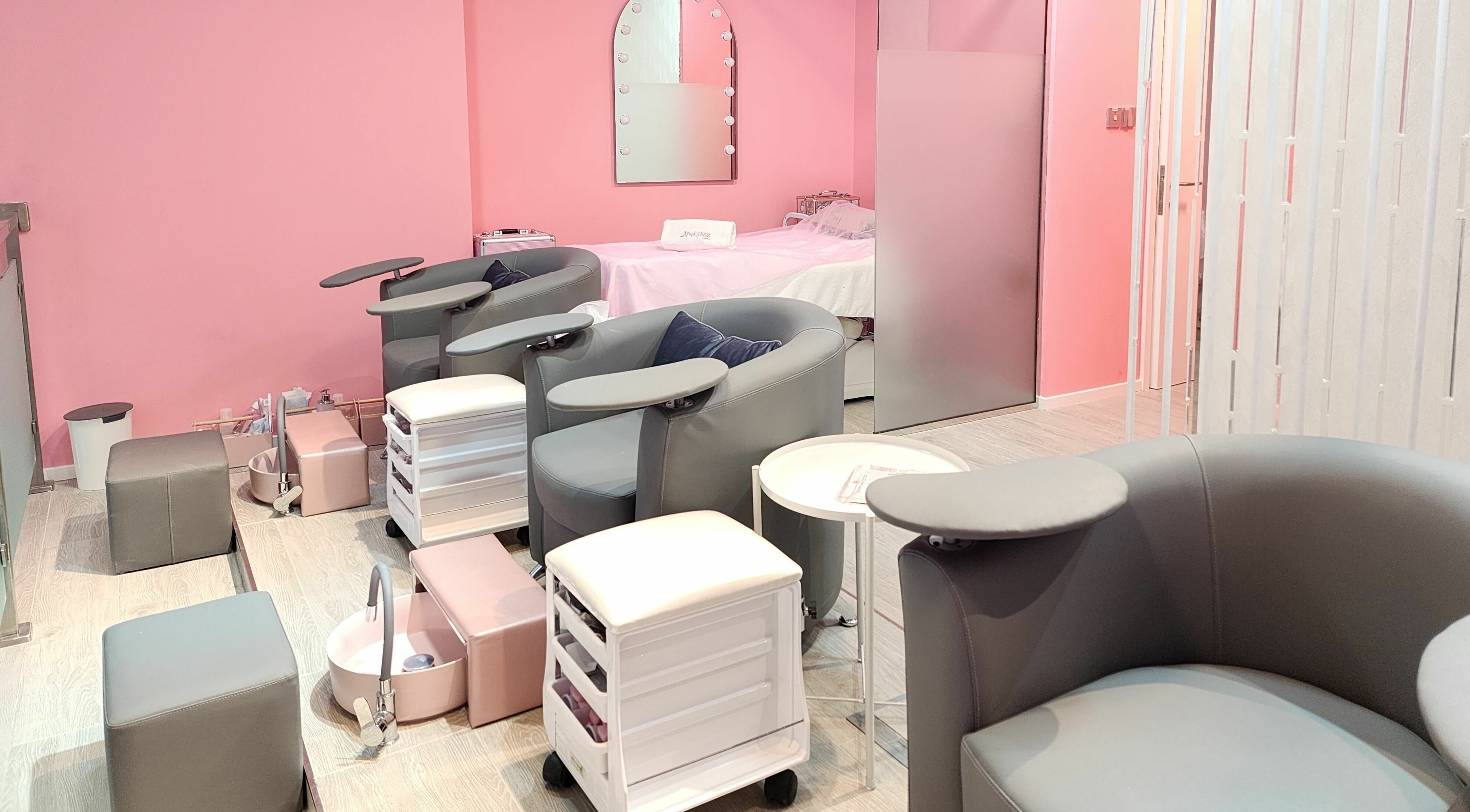 Elegant nail spa lounge at Pink Stiletto by Shweta, Dubai, Dubai, AE with modern seating and pastel decor.