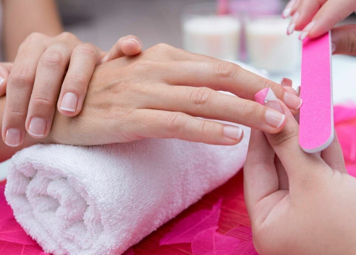 Manicure session at Pink Stiletto by Shweta, Dubai, Dubai, AE with focus on nail filing.