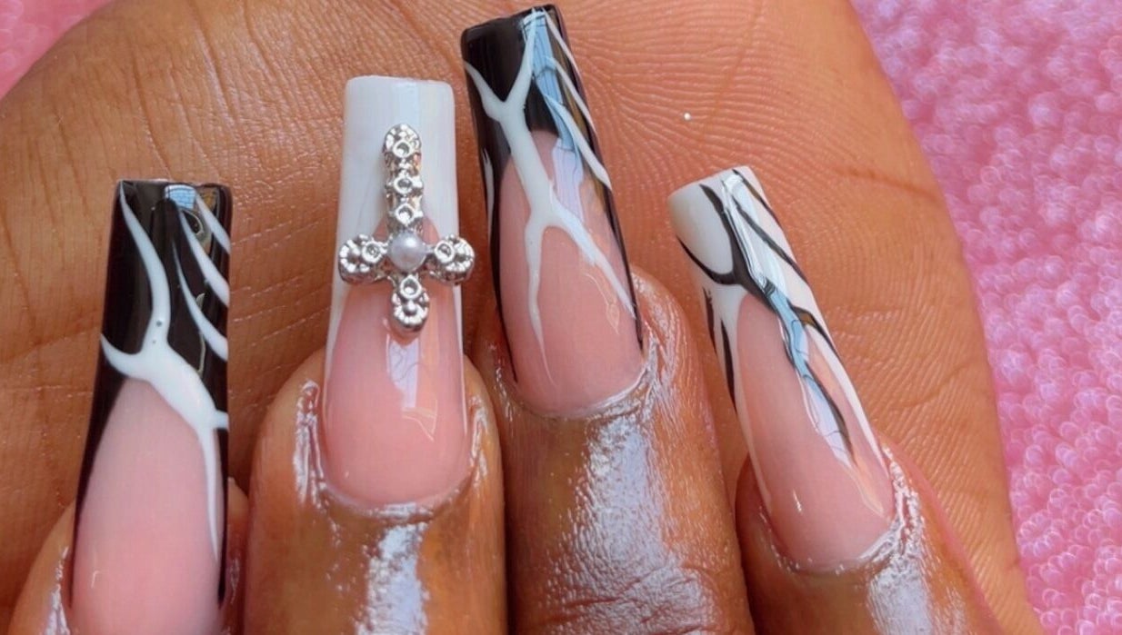 Intricate nail art at Beautify Me by LC, Montego Bay, St. James Parish, JM showcasing detailed black and white designs.