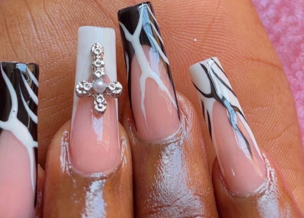 Intricate nail art at Beautify Me by LC, Montego Bay, St. James Parish, JM showcasing detailed black and white designs.