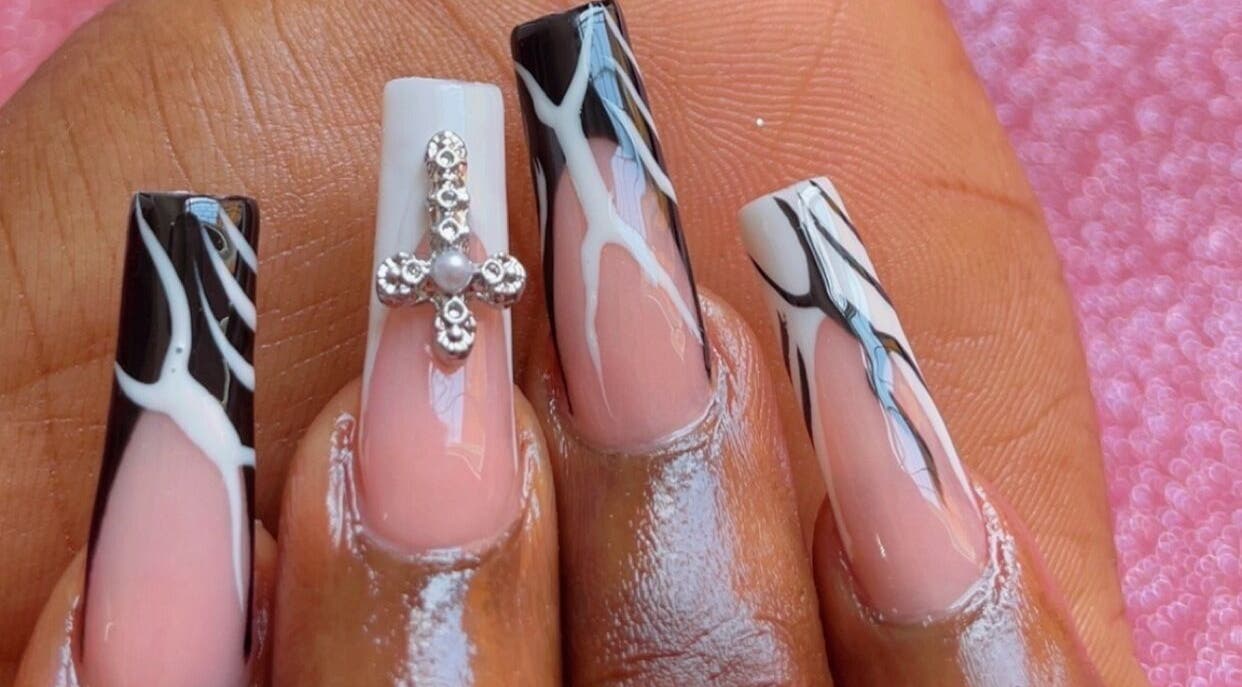 Intricate nail art at Beautify Me by LC, Montego Bay, St. James Parish, JM showcasing detailed black and white designs.