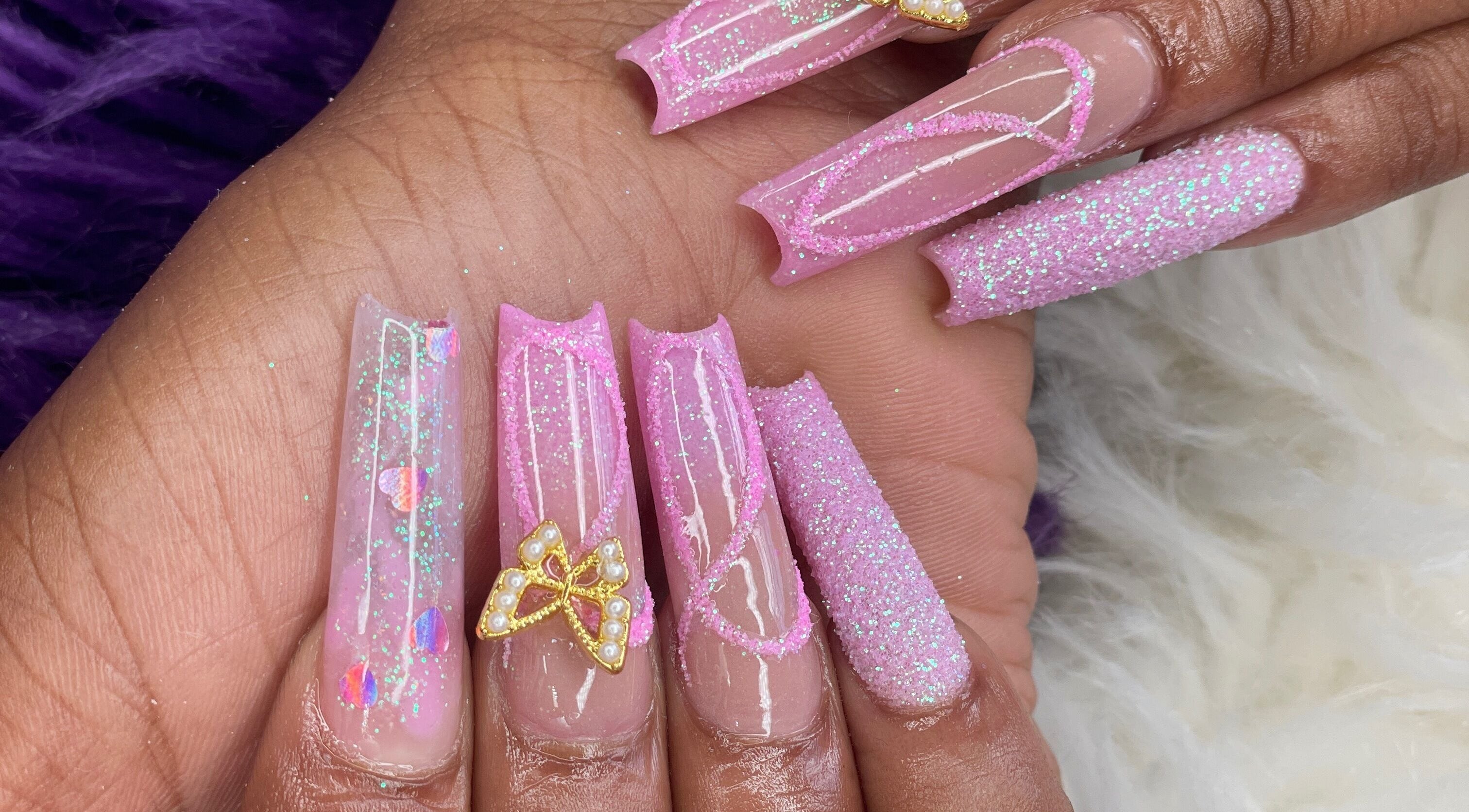 Pink glitter nails with butterfly art at Beautify Me by LC, Montego Bay, St. James Parish, JM.