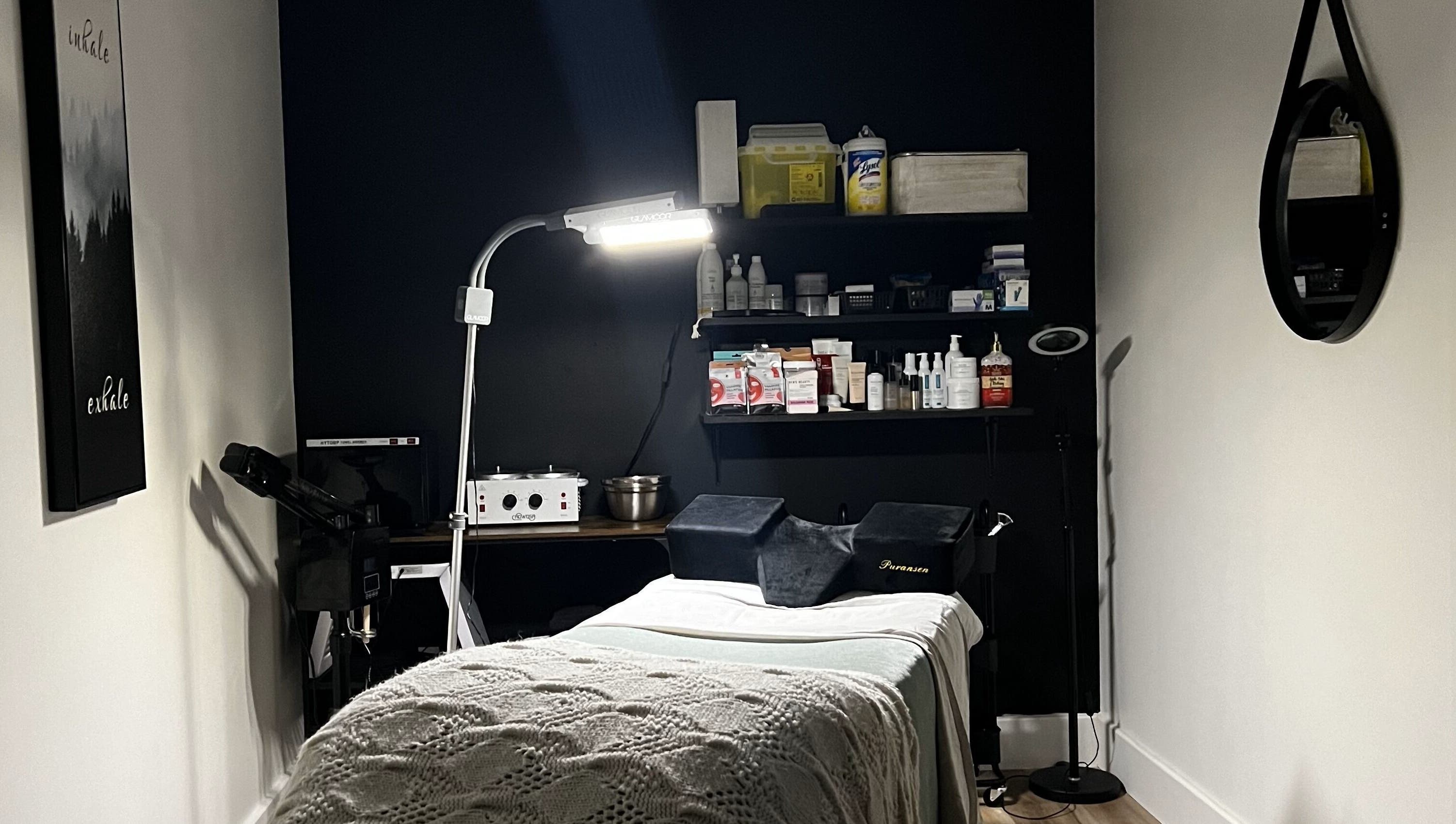 Calm treatment room at The Loft Spa, Barrington Passage, Nova Scotia, CA with cozy bed and warm lighting.