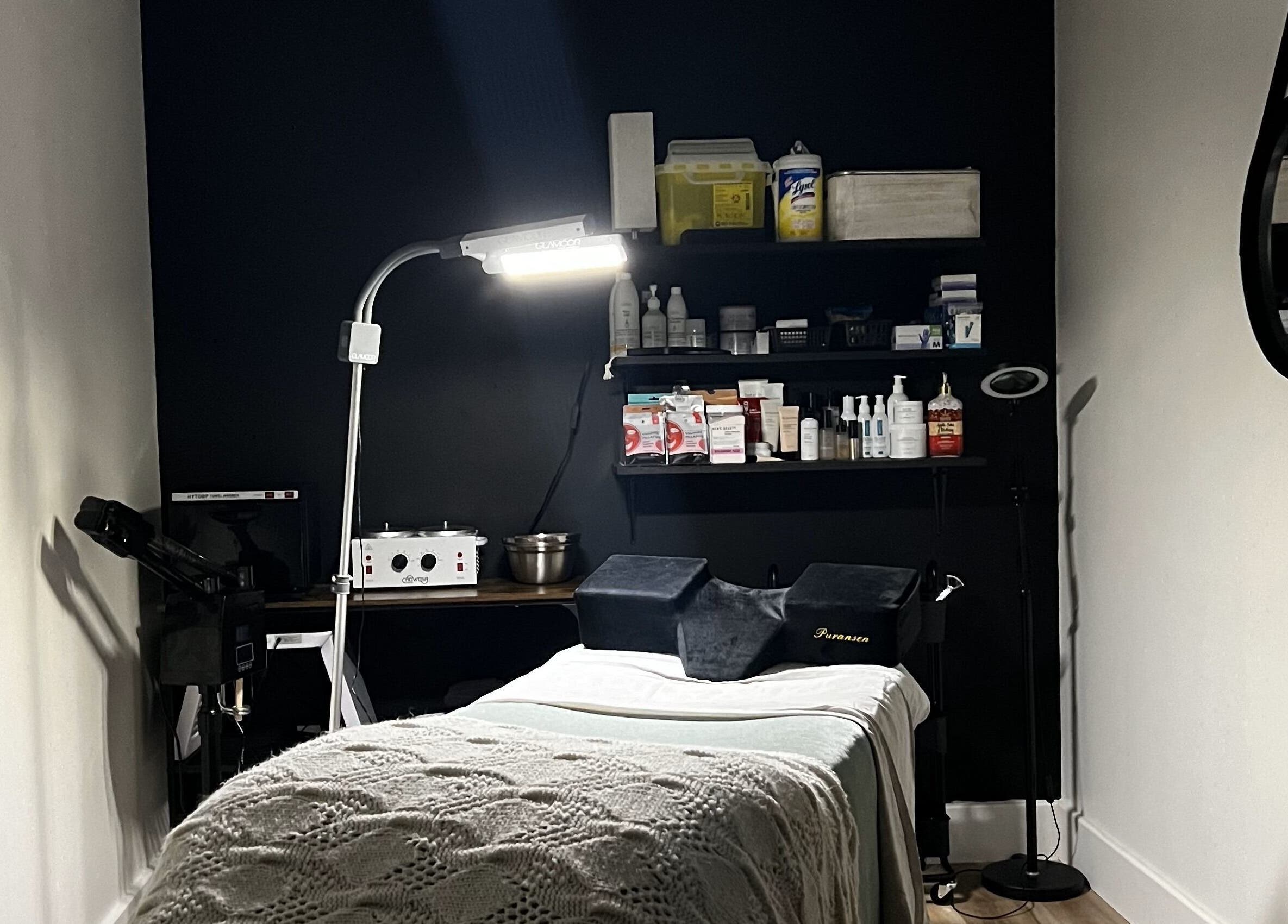 Calm treatment room at The Loft Spa, Barrington Passage, Nova Scotia, CA with cozy bed and warm lighting.
