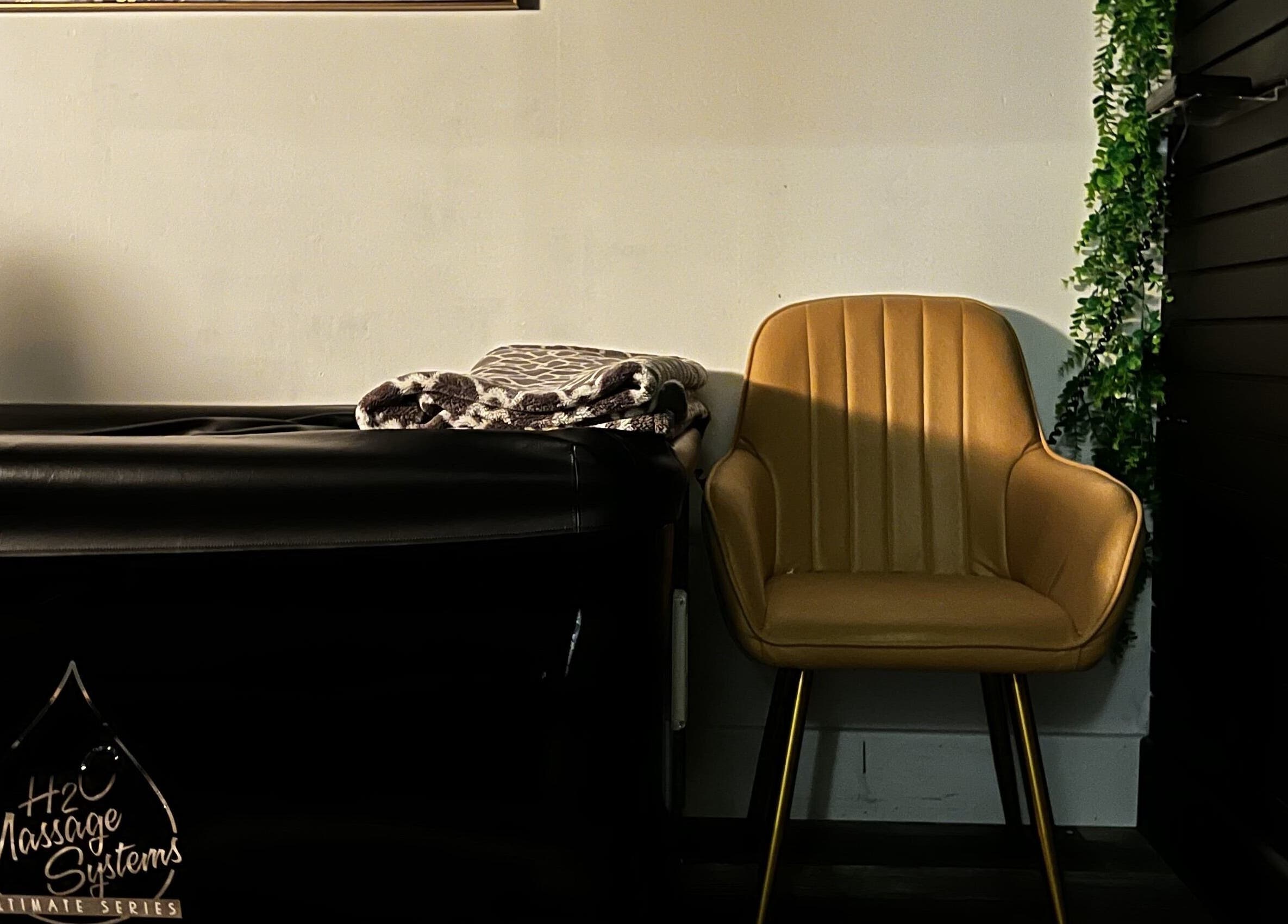 Cozy massage chair at The Loft Spa, Barrington Passage, Nova Scotia, CA, with plush blankets for comfort.