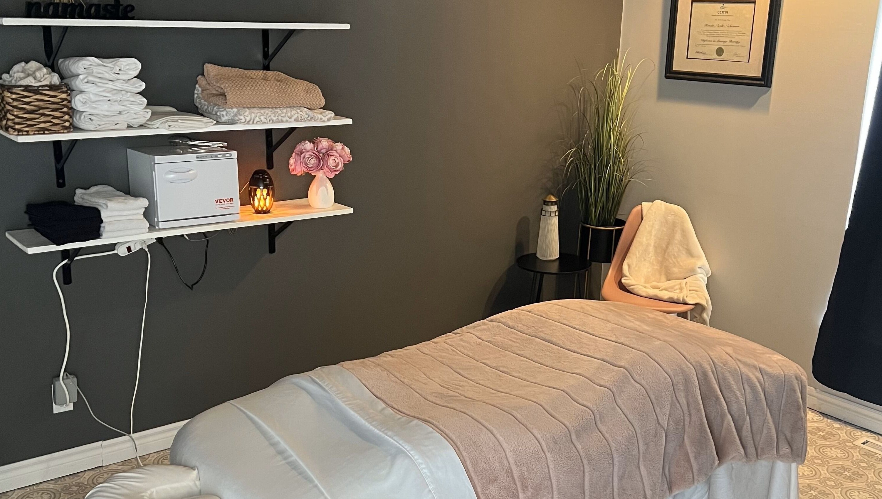 Relaxing therapy room at The Loft Spa, Barrington Passage, Nova Scotia, CA with a massage table and warm lighting.