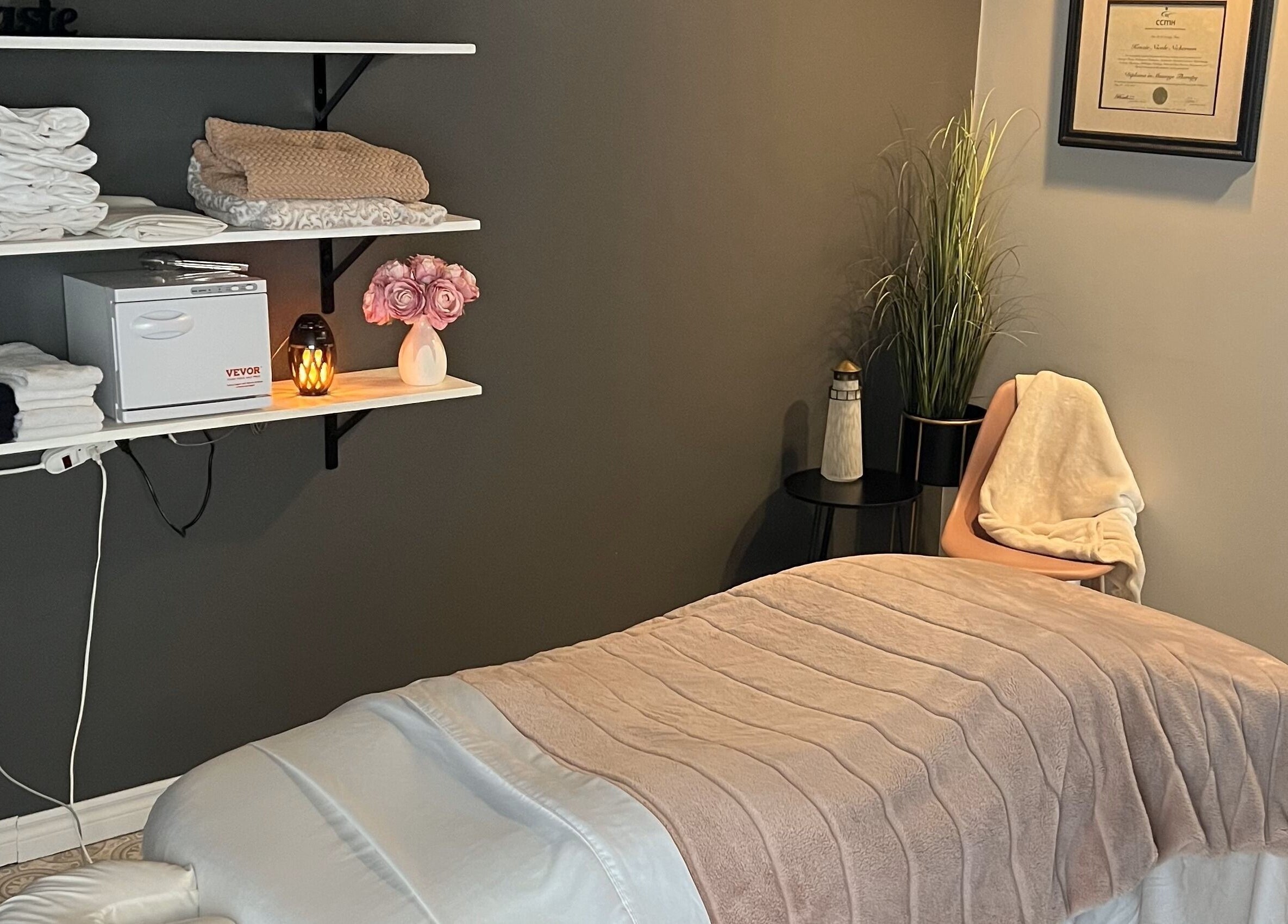 Relaxing therapy room at The Loft Spa, Barrington Passage, Nova Scotia, CA with a massage table and warm lighting.