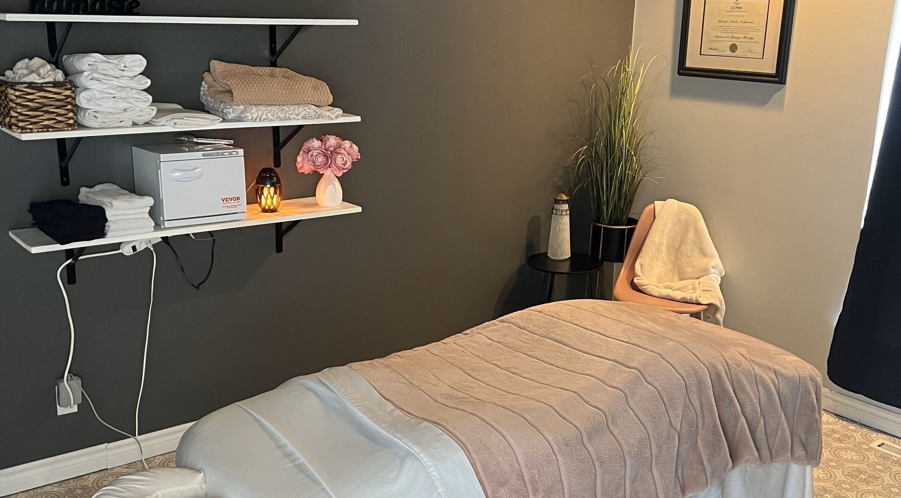 Relaxing therapy room at The Loft Spa, Barrington Passage, Nova Scotia, CA with a massage table and warm lighting.