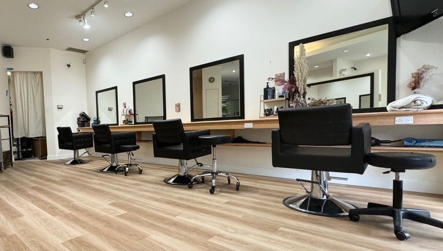 Modern interior of CuE Hair Salon Vancouver, located in Vancouver, British Columbia, CA, showcasing stylish salon chairs.