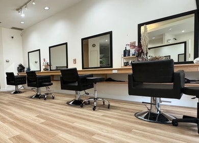Modern interior of CuE Hair Salon Vancouver, located in Vancouver, British Columbia, CA, showcasing stylish salon chairs.
