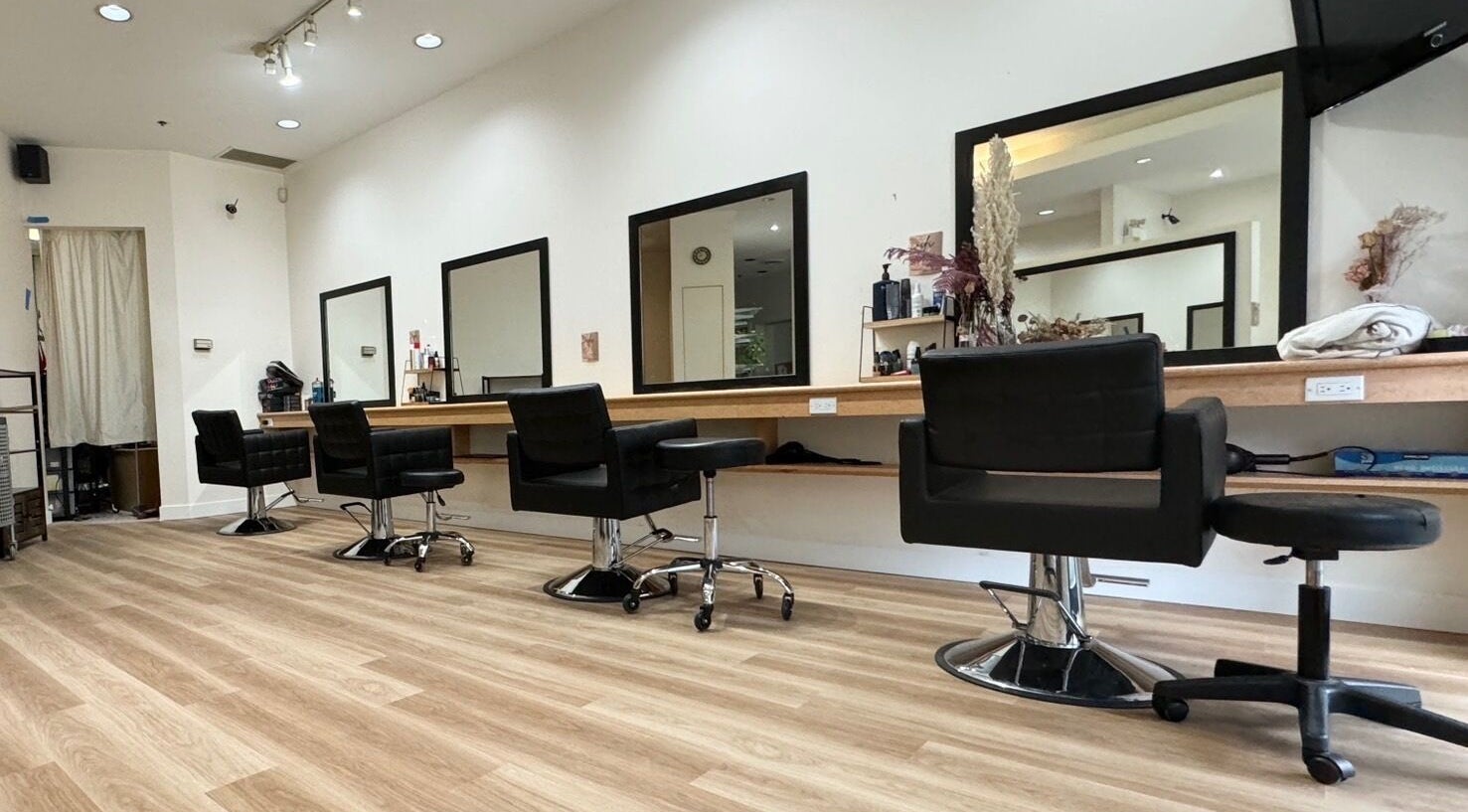 Modern interior of CuE Hair Salon Vancouver, located in Vancouver, British Columbia, CA, showcasing stylish salon chairs.