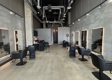 Stylish interior of CuE Hair Salon Richmond, Richmond, BC, CA with modern design and sleek styling stations.