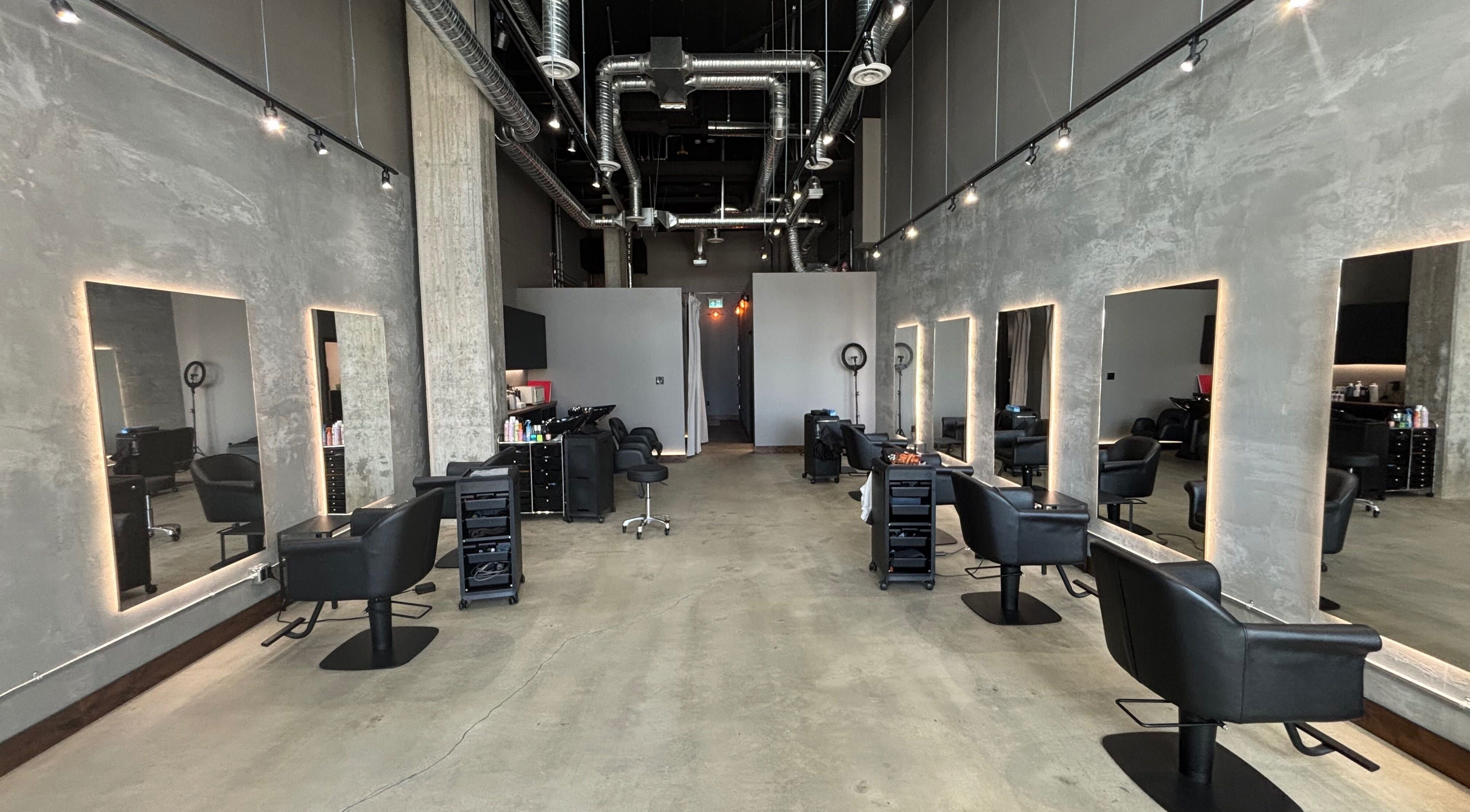 Stylish interior of CuE Hair Salon Richmond, Richmond, BC, CA with modern design and sleek styling stations.