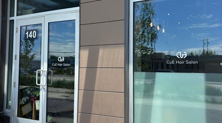 Entrance of CuE Hair Salon Richmond, showcasing modern glass doors, Richmond, British Columbia, CA.