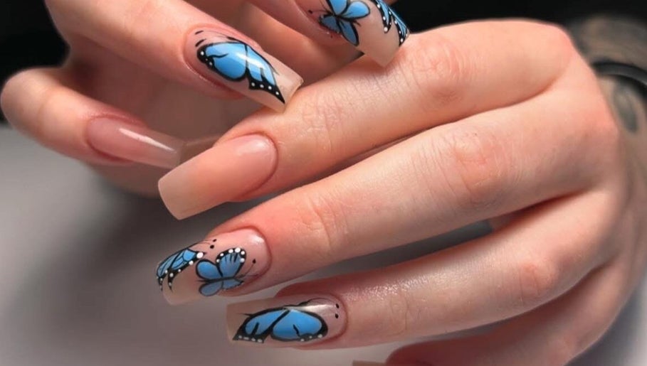 Butterfly nail art at Mimisnailbar, Barkingside, Ilford, England, GB showcases intricate blue designs.
