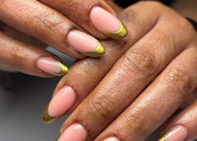 Elegant gold-tipped nails at Mimisnailbar, Barkingside, Ilford, England, GB showcasing professional manicure.