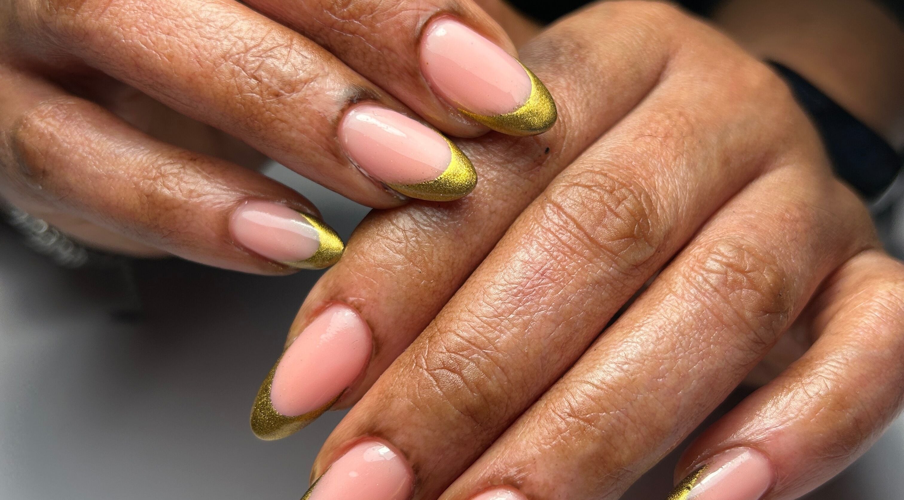 Elegant pink nails with gold tips at Mimisnailbar, Barkingside, Ilford, England, GB, showcasing luxury nail art.