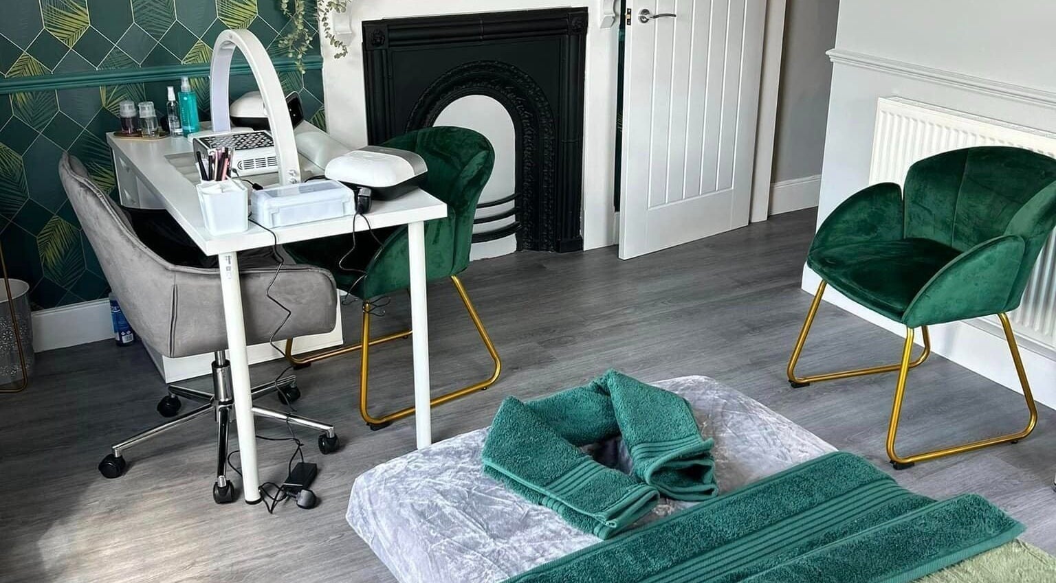 Vanity Fayre's elegant treatment room in Donington, England, GB, featuring plush chairs and a stylish nail station.