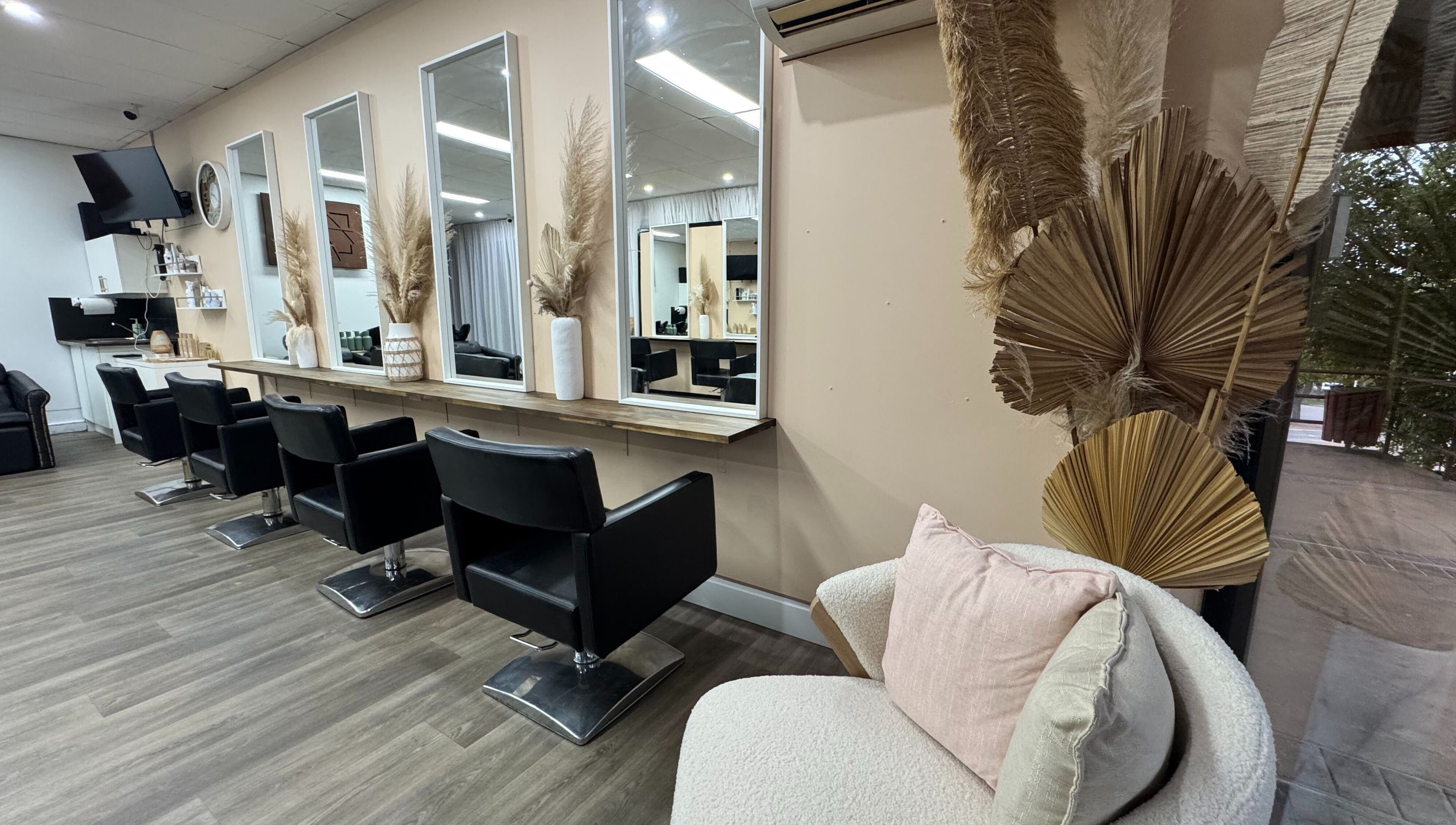 Modern salon interior at Amour Hair, Wyong, New South Wales, AU, with stylish chairs and mirrors.